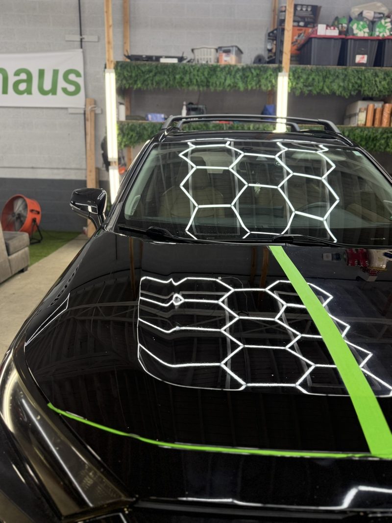 Paint correction result on a black SUV hood at DetailHaus