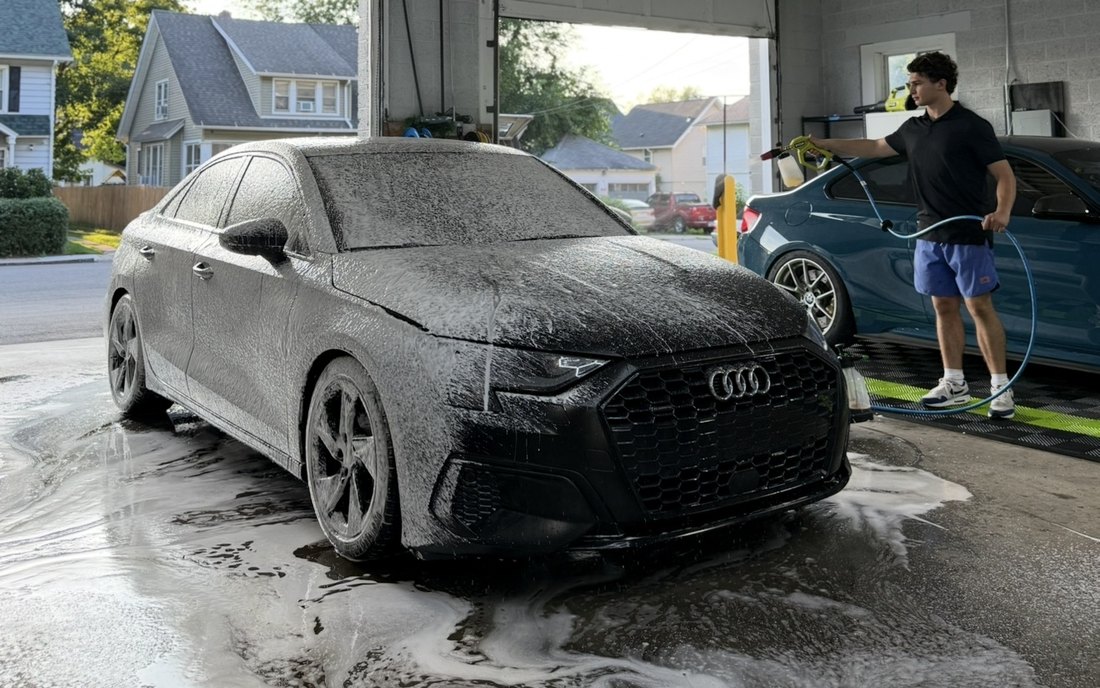 Matte black Audi covered in foam during a full detail at DetailHaus